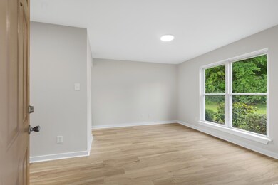 Empty room with light wood finished floors and bas
