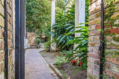 Gated entry leading to shared courtyard. Unit is u