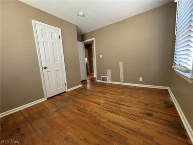 Empty room featuring dark hardwood / wood-style flooring