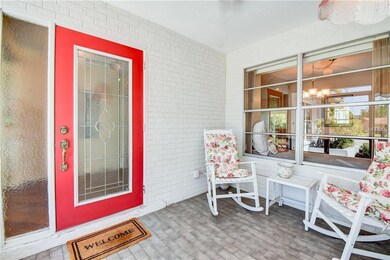 A leaded glass door in the screened front porch gi