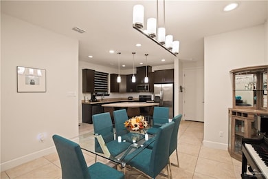 Dining space featuring recessed lighting and light tile patterned floors