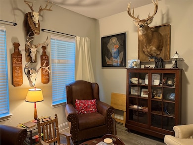 Living area featuring baseboards and wood finished floors