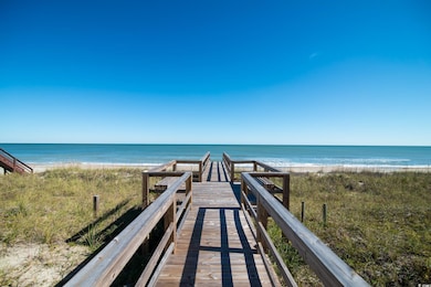 View of home's community with view of water and beach