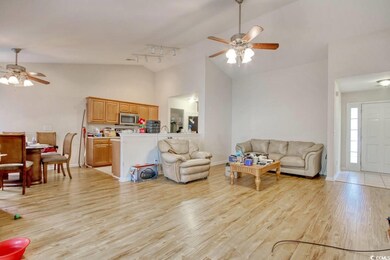 Living room featuring rail lighting, ceiling fan, 