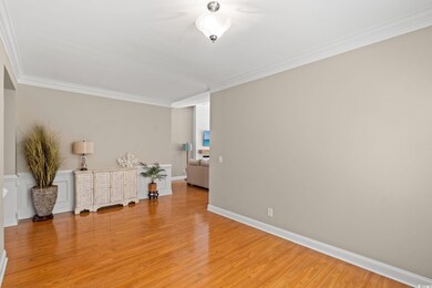 Dining room featuring ornamental molding and light wood-style flooring