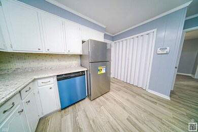 Kitchen with view of laundry area behind the accor