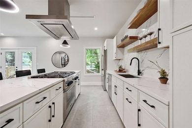 Kitchen featuring white cabinets, open shelves, a