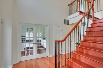 To the left of the foyer, through French doors is