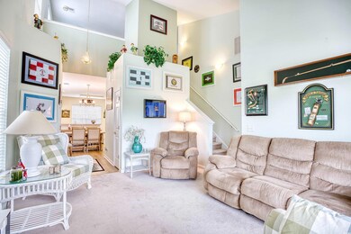 Living room featuring a towering ceiling, light ha
