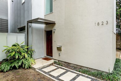 Walkway leading to wooden front door.