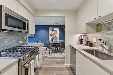 Kitchen with backsplash, appliances with stainles