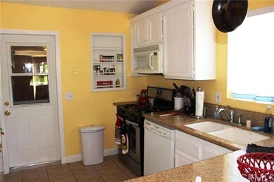 Kitchen with granite counter tops and door to the 