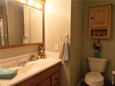 Master Bath, Main Level. Featuring honey oak vanit