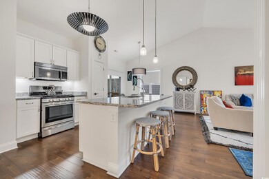 Kitchen featuring white cabinetry, appliances with