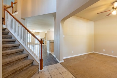 Entryway with a ceiling fan, light colored carpet