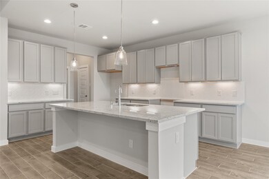 This kitchen is by far any chef’s dream! This spacious kitchen features high ceilings, cool stained wood cabinets, granite countertops, SS appliances, modern tile backsplash, recessed lighting with additional custom pendant lighting, extended counter space, granite kitchen island with space for breakfast bar, and a walk-in pantry all overlooking your huge family room.
