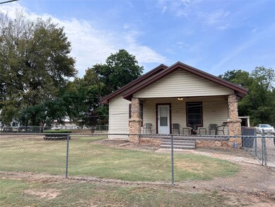 View of front of home with covered porch and a fro