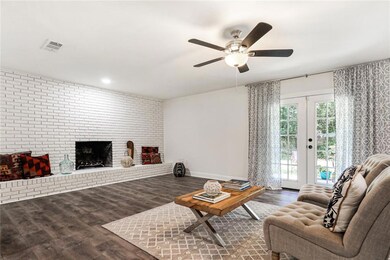 Double doors lead to patio space in large backyard