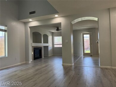 Unfurnished living room featuring arched walkways,