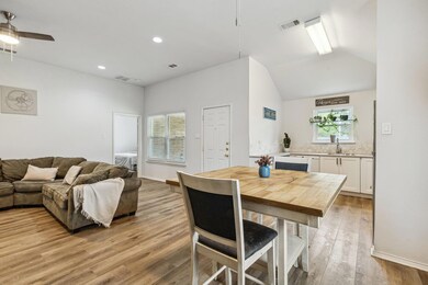 Dining area with a ceiling fan, light wood-type fl