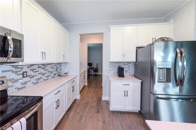 Kitchen featuring stainless steel appliances, whit