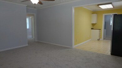 Living room w/view of kitchen and hall