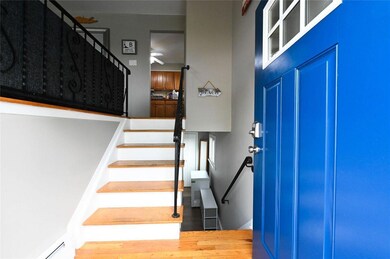 Entrance foyer with stairway, wood finished floors, and a ceiling fan