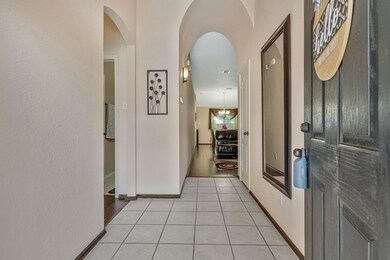 Hallway with light tile flooring