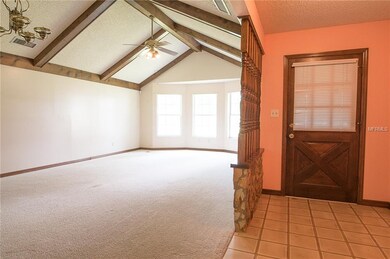 Entry and Living room dining room with vaulted cei