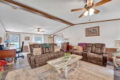 Living room featuring vaulted ceiling with beams, 