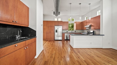 The wet bar flows into the open kitchen, offering