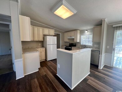 Kitchen featuring white fridge, electric range, di