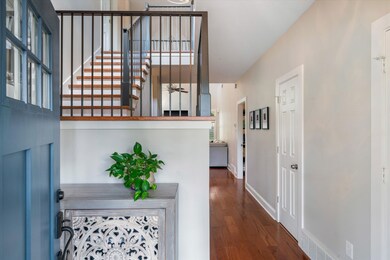Entrance foyer with dark hardwood / wood-style flo
