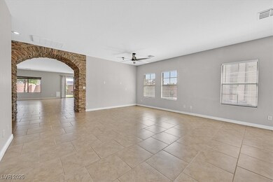 Spare room with ceiling fan, arched walkways, ligh