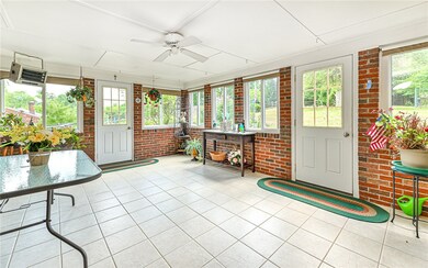 Sun drenched bonus room is heated and has two door