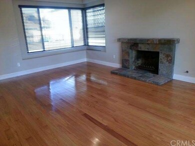 Living Room with cozy fireplace, gleaming hardwood