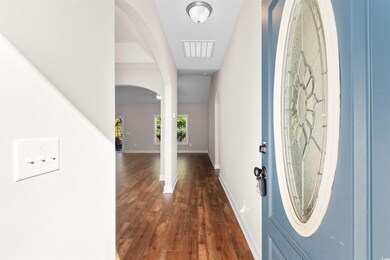 Foyer entrance featuring ceiling fan and dark hard