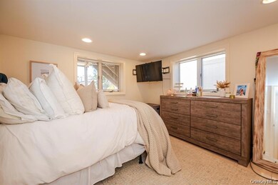 Bedroom with recessed lighting and light carpet