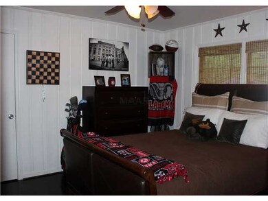 This bedroom has dark hardwood floors and a great 