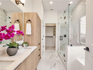Bathroom featuring a marble finish shower, marble 
