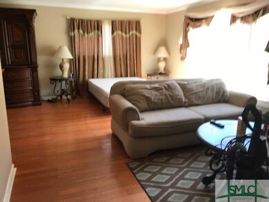 Large living room featuring wood laminate flooring