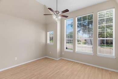 Empty room featuring light wood-type flooring and ceiling fan