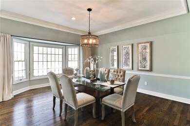 Entertain elegantly with bay windows and coffered ceiling