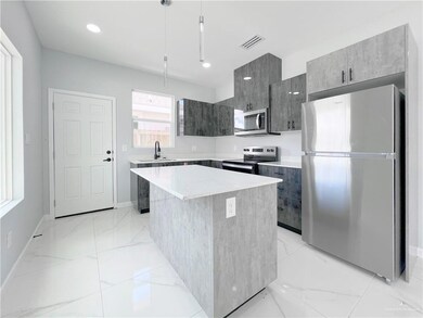 Kitchen with visible vents, modern cabinets, marble finish floor, appliances with stainless steel finishes, and light countertops