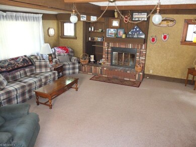 Spacious living room with wood burning fireplace.