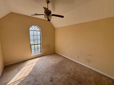 Carpeted empty room featuring lofted ceiling, ceil