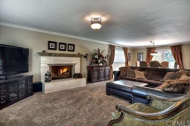 Living Room with Fireplace, High Ceilings, and Cro