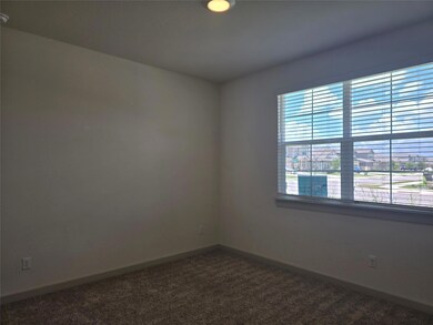 Unfurnished room featuring dark carpet and basebo