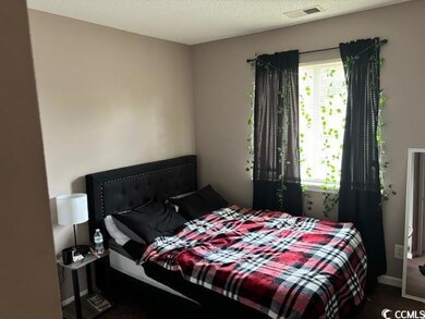 Bedroom featuring a textured ceiling