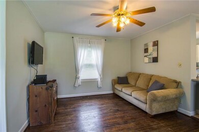 View from the front door. Notice the hardwood floors and ceiling fan